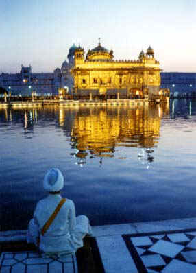 Dharma Singh Khalsa watching the sun rise behind the Golden Temple
