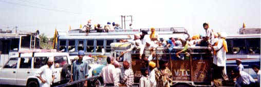 The streets filled with buses, trucks, carts and people going to Anandpur. - Photo: Guruka Singh Khalsa