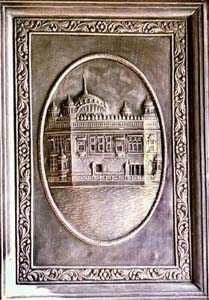 A silver engraving of the Golden Temple on the door of a Gurdwara in Punjab.