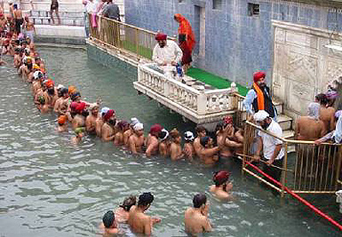 On Baisakhi festival, devotees take a holy bath in the sarovar of Gurdwara Panja Sahib at Hassan Abdal, 48 km north of Islamabad, on Friday